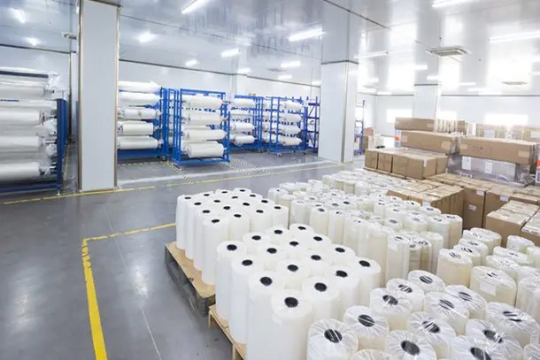 Pallets of water-soluble PVA film rolls in a warehouse, sorted by dissolving grade